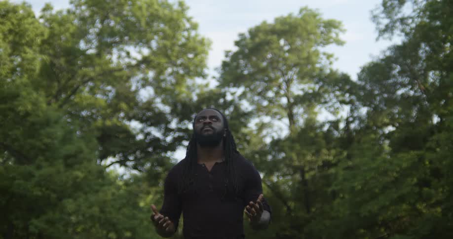 A man is praying outdoors