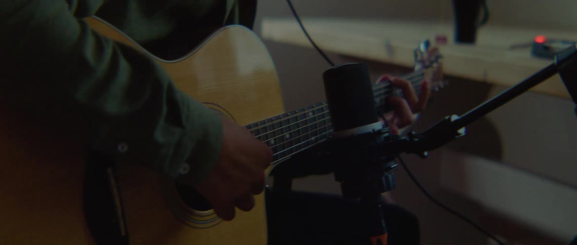 Person recording guitar