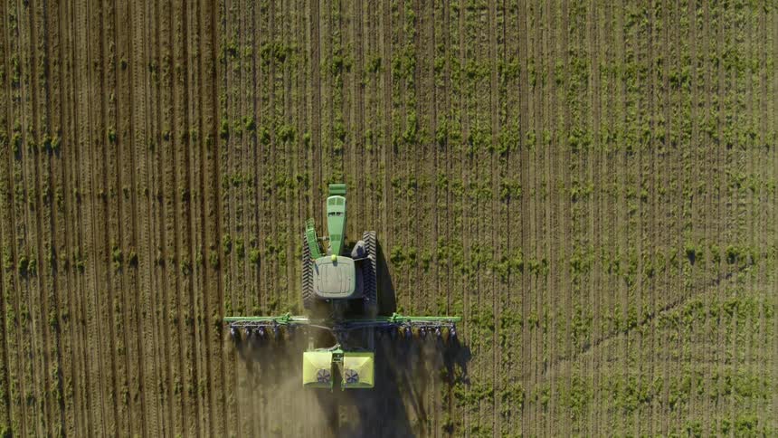 Medium top down view of a modern tractor planting seeds