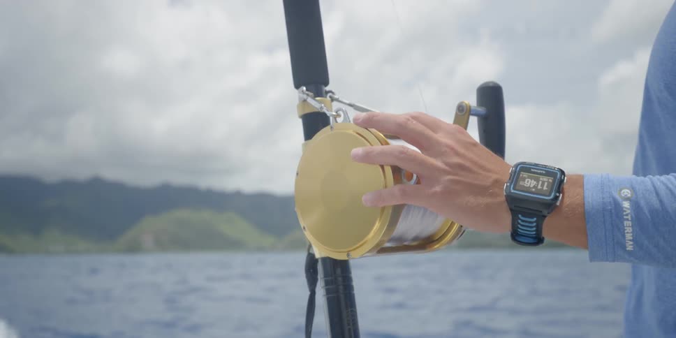 A person is operating a fishing pole on a boat