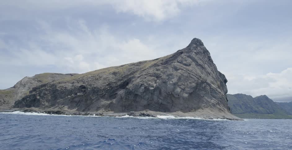 A rock formation surrounded by water