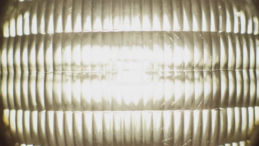 Faceted surface of a headlight turning on at night
