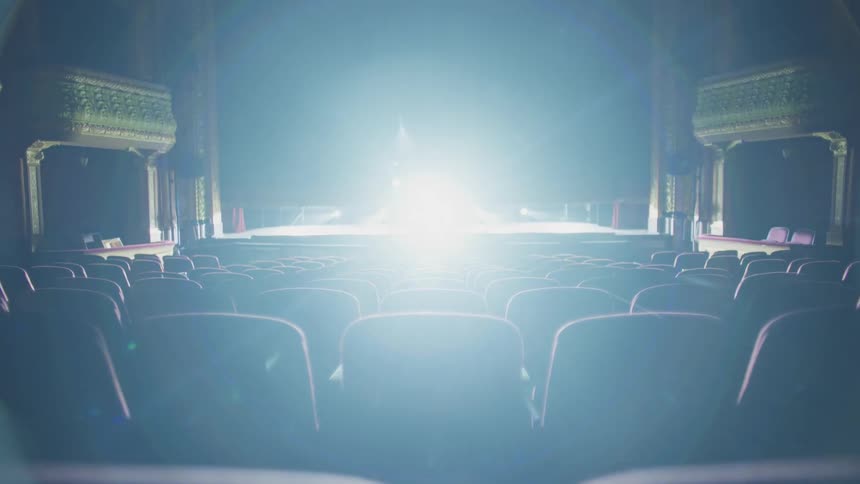 A view of a curtain coming down on a stage