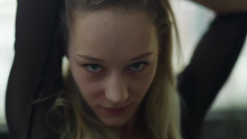 A woman dancing in front of a camera