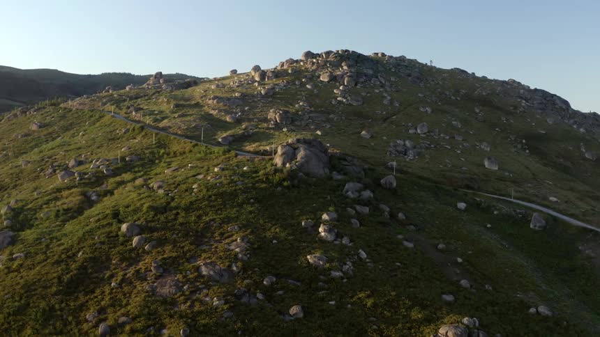 Aerial view of rocky hill with road on the slope