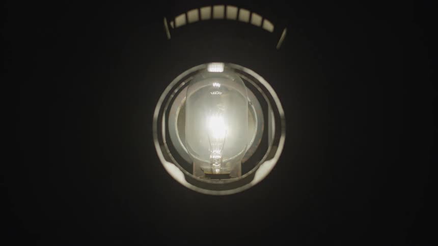A lightbulb in a pipe in the darkness