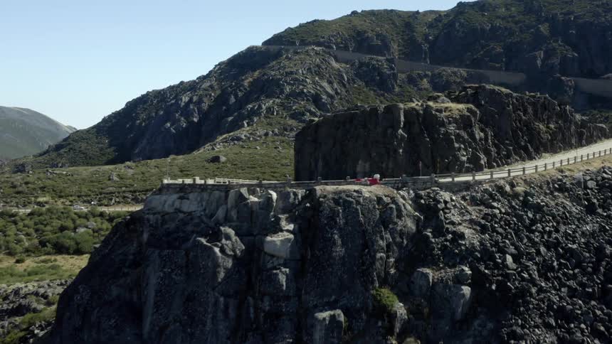 Cars drive on the winding roads over the mountains