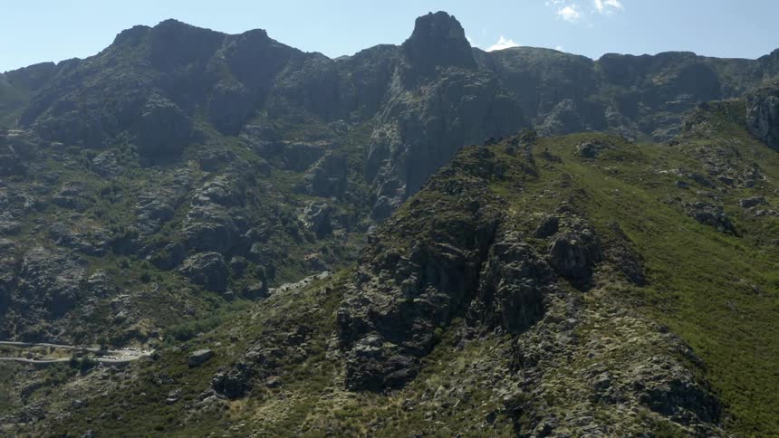 Rocky mountains high in the sky and a valley below