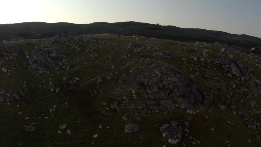 Aerial view of rocky mountain slope at dusk