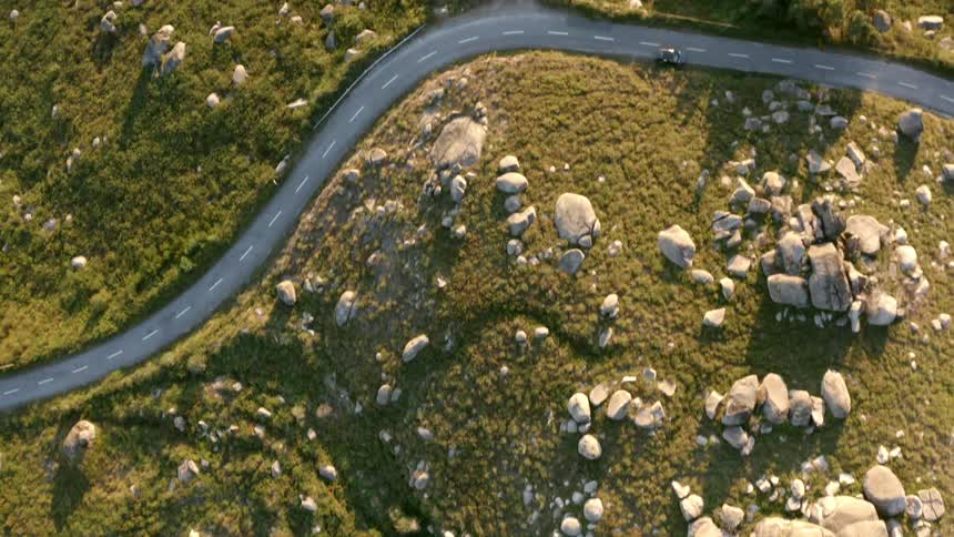 Aerial view of mountain highway on slope with rocks