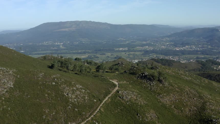 Aerial view of mountain pass with distant town