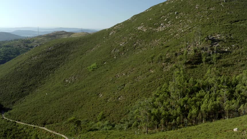 An aerial view of hills with grass on them