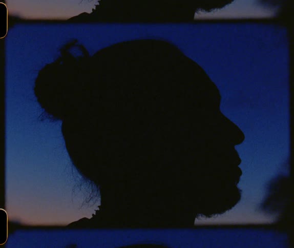 Film footage of a silhouette of a mans face outside