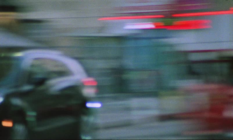 A view of cars driving around in a large city