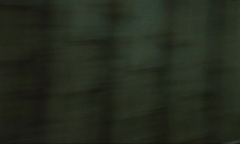 Chaotic camera movements capture a citys downtown area from the street level at dusk