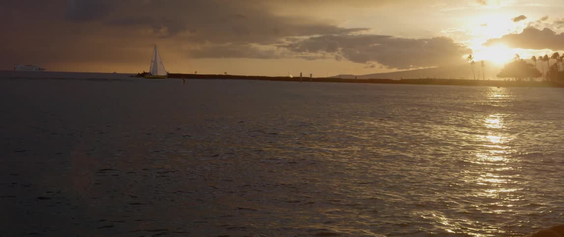Sailboat on the water during a golden sunset