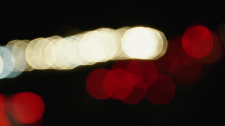 Red and white lights shimmer and twinkle as they float left to right