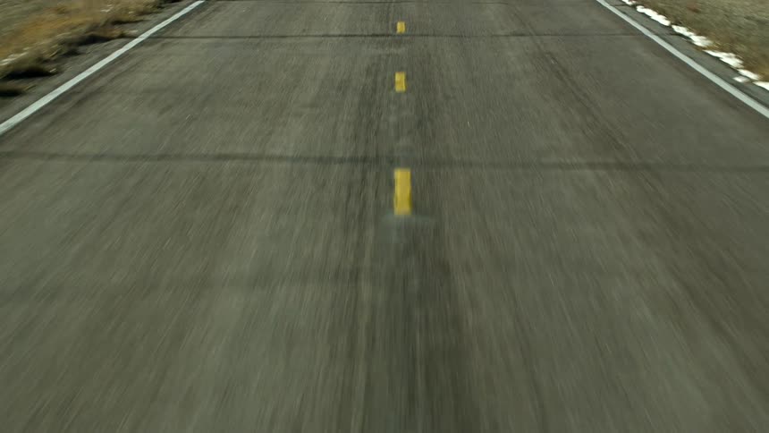 A vehicle traveling over a paved road