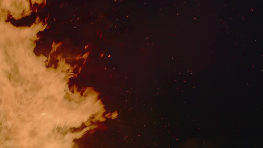 Flames shoot outward as a fire grows bigger
