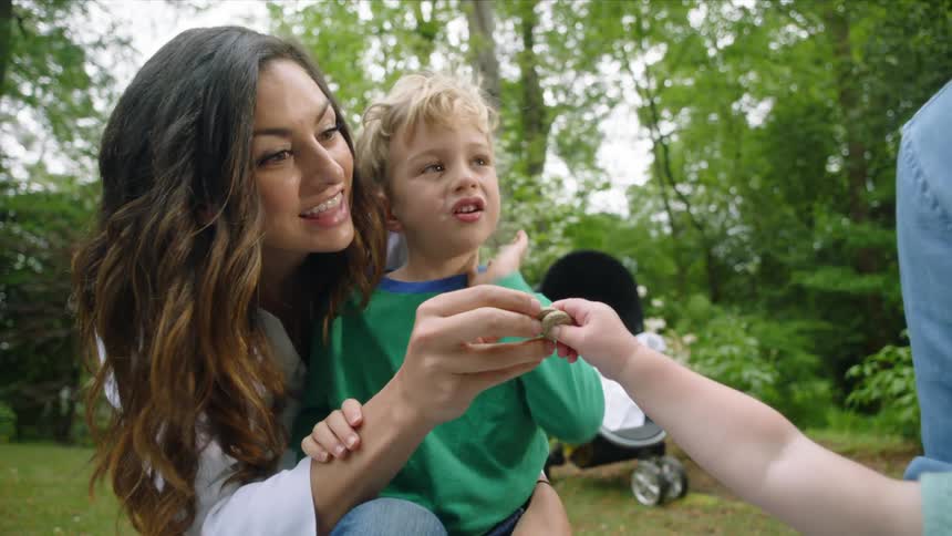 A family playing together outdoors at a park