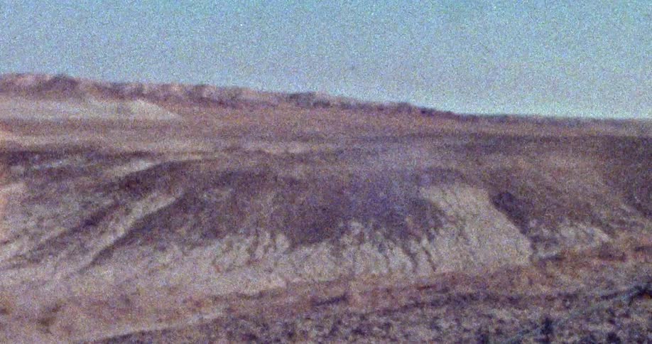 Plain stretches between slope and mountains