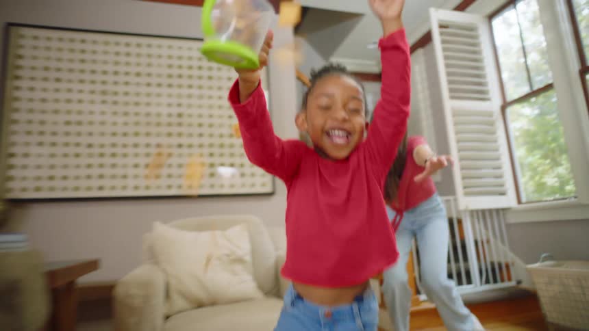 A mother chasing her daughter around the house playing