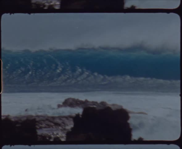 A large wave crashes on the shore