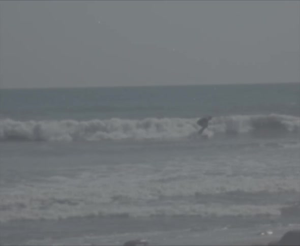 Surfers are riding waves in rough water