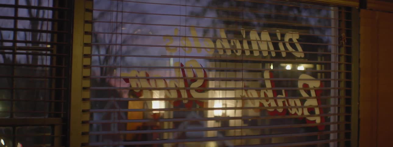 Blinds are slightly opened in this shop window