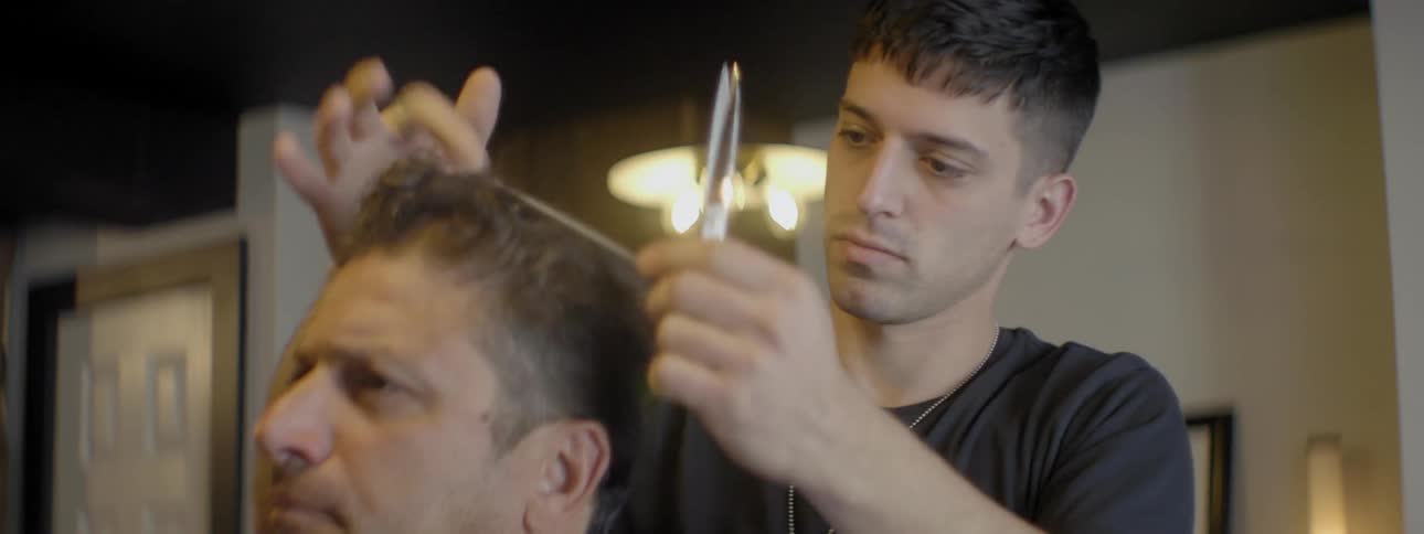A man is snipping hair
