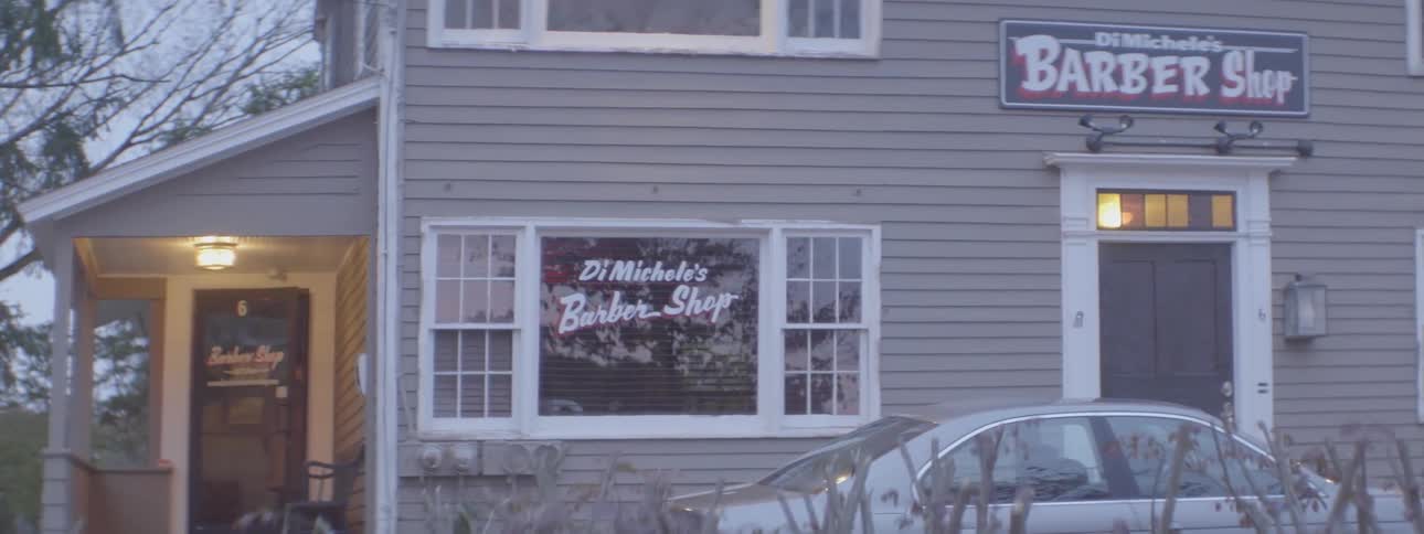 Man turns on lights in a barber shop