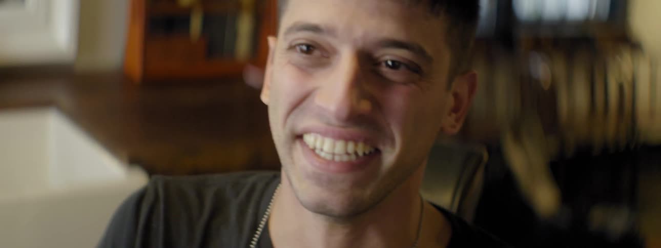 A man laughs in a room