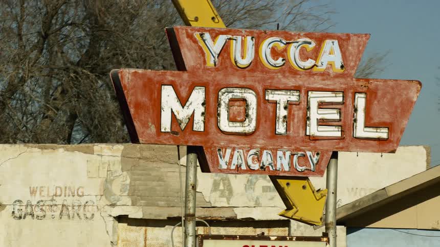 Signt outside a motel near the road in a small town at morning