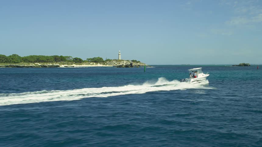 A person is driving a boat on a body of water