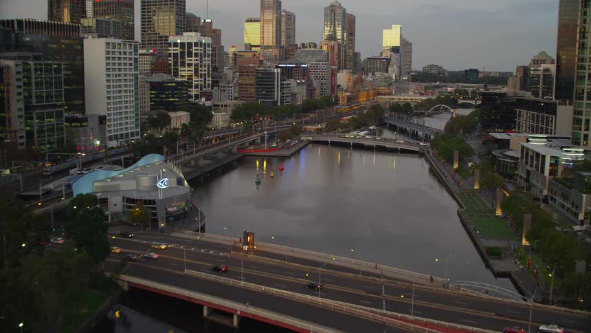 A river with a lot of bridges over it runs through a city