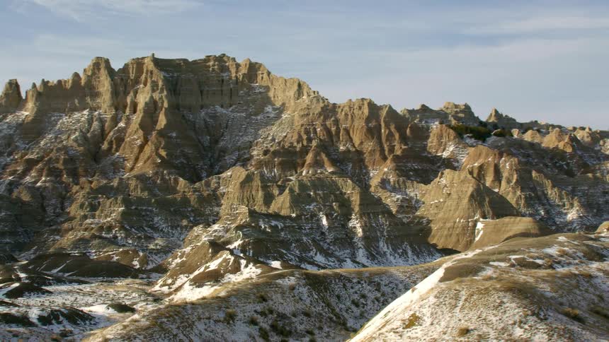 Aerial view of snow covering the slopes and ridges of a mountain range