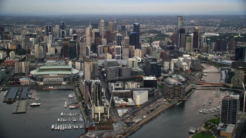 An aerial view of a large metropolis with a canal in the evening
