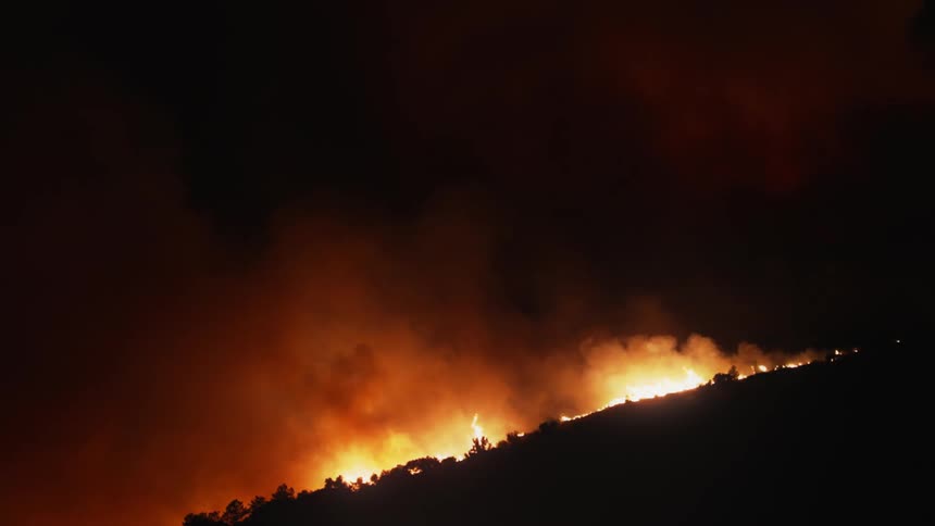 A view of a fire burning on a mountain