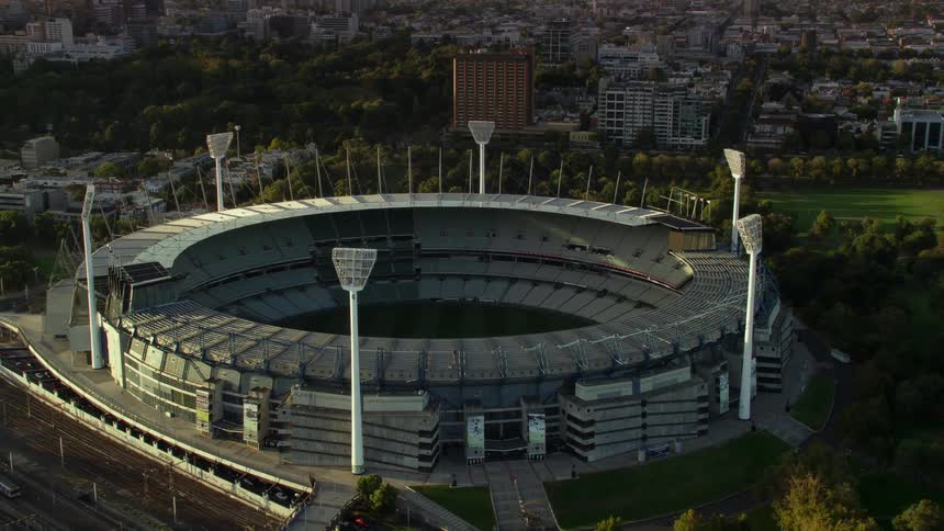 A large stadium sits near the city