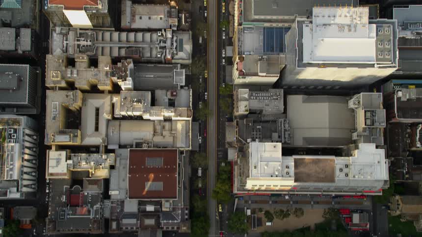 Aerial view of cars driving on the city streets at morning