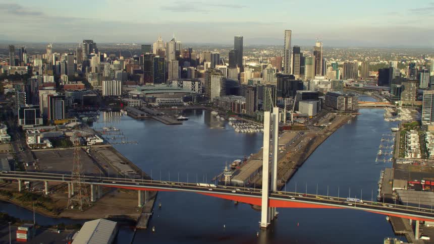 Vehicles travel over the large bridge in the city