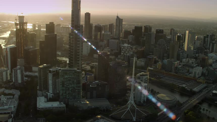 Bright sunlight shines on a big city with tall buildings and skyscrapers