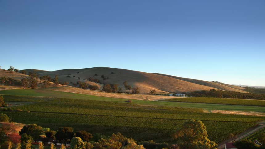 A large hill in the countryside under a clear blue daytime sky