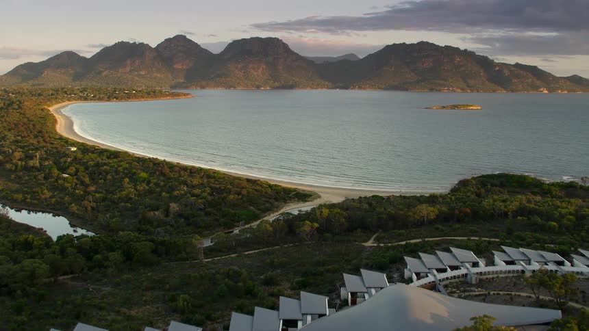 An aerial view of buildings near a beach on a summer morning