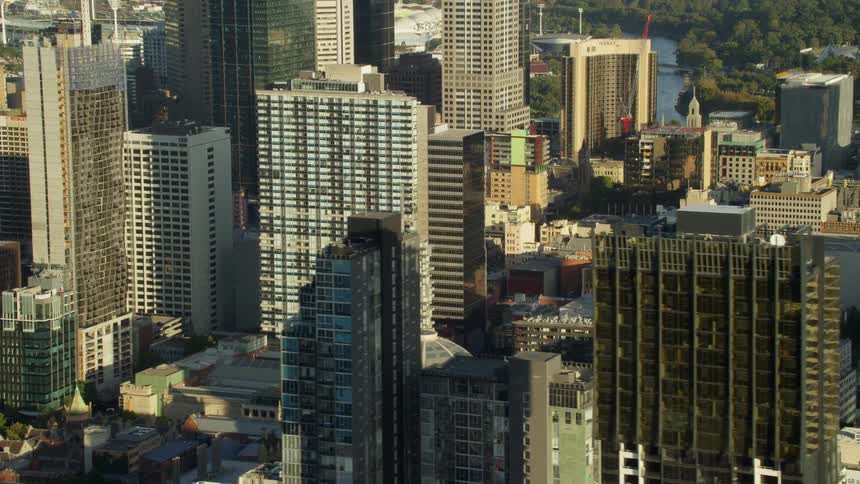 A city skyline with buildings skyscrapers trees and a river