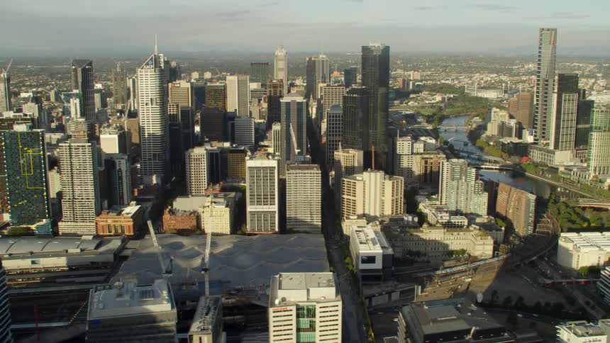 An aerial view of buildings and tall skyscrapers in a large city in the daytime