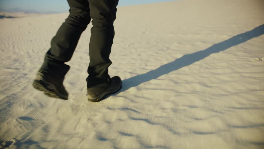 A person walking over a snowy field on a winter day