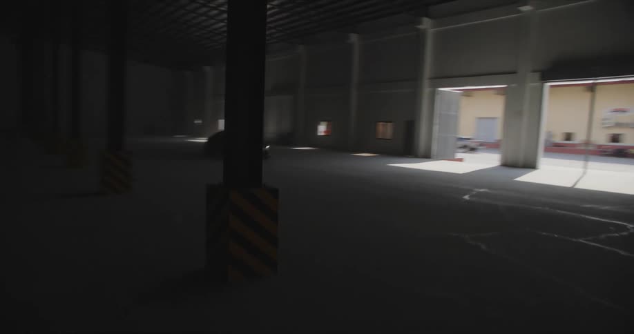 A car driving through a dark warehouse