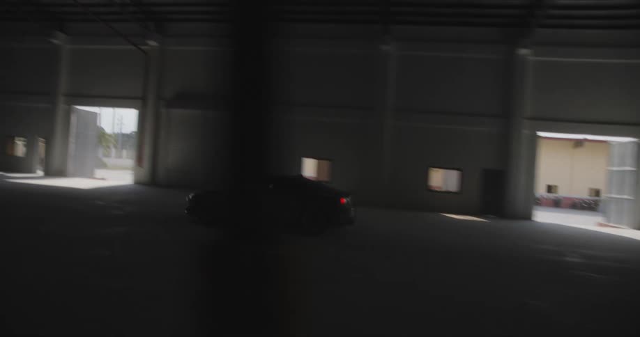 A car driving near a building at night