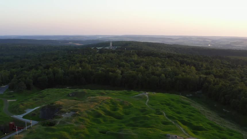 A golf course sits next to a vast forest